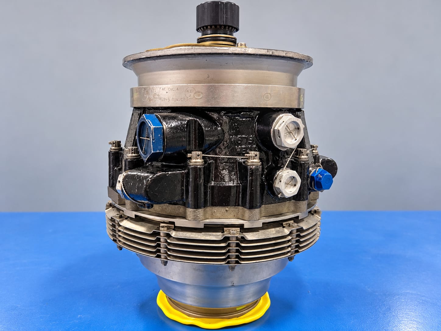 Aircraft rotary component assembly with protective caps on a blue workbench